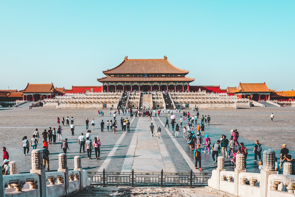 Visitors crossing the grand courtyard of the Forbidden City in Beijing