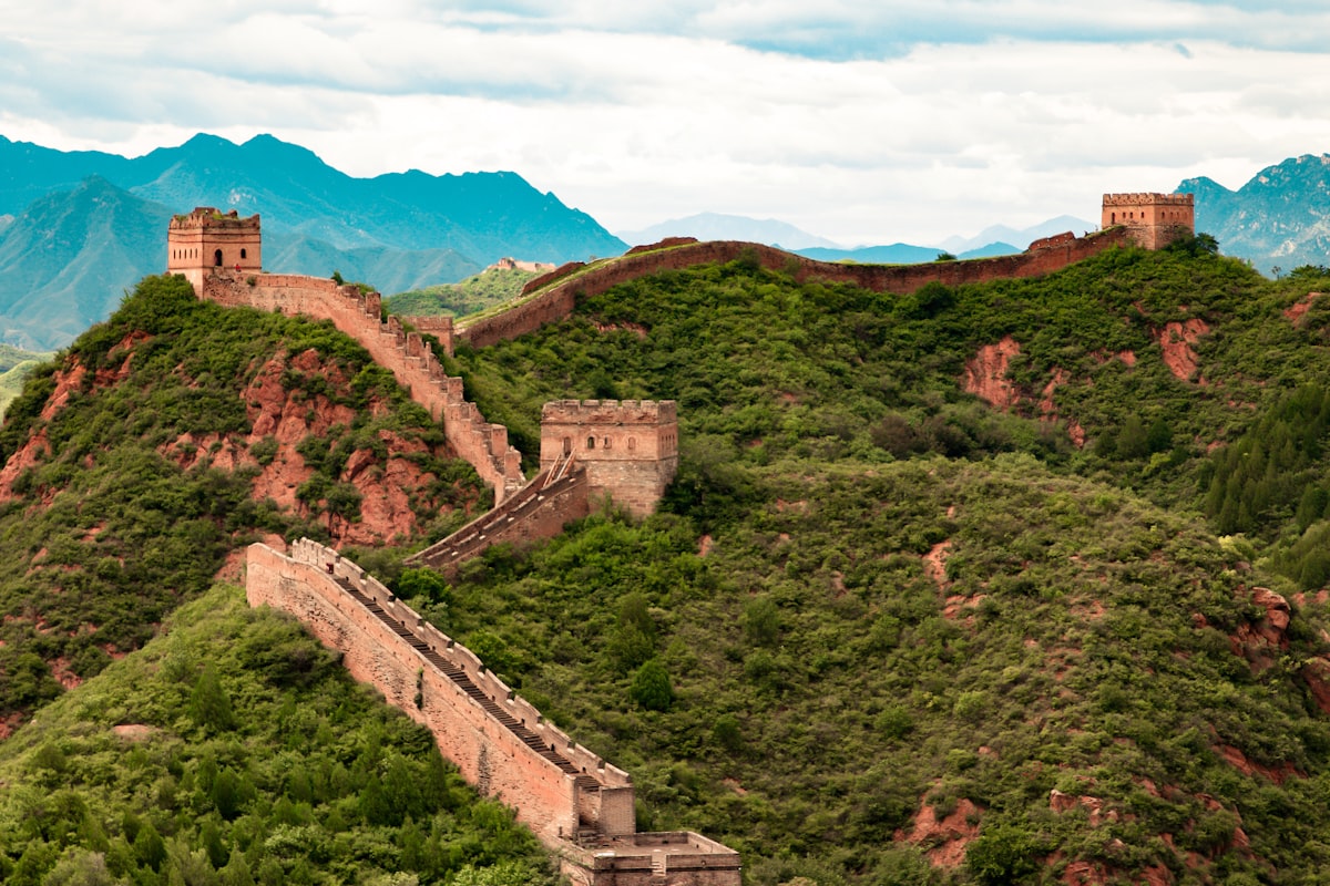 The Great Wall of China winding over green ridges at Jinshanling near Beijing
