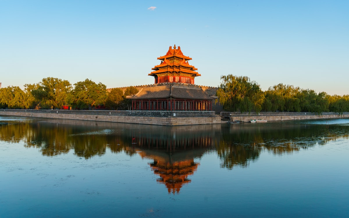 Corner watchtower of Beijing's Forbidden City reflected in the palace moat
