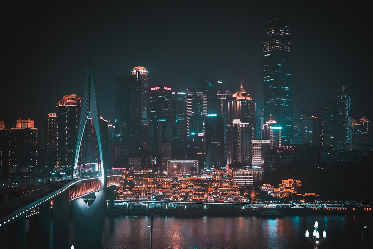 Hongyadong and Qiansimen Bridge lit up at night along the Jialing River in Chongqing