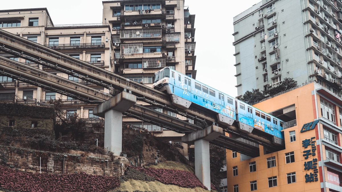 A monorail train passes through a residential building at Liziba station, Chongqing