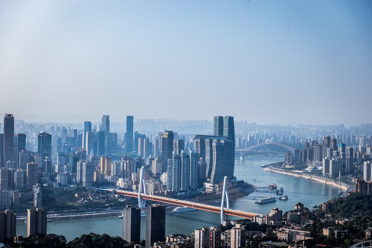 Daytime view over Chongqing's rivers, bridges and layered high-rise skyline
