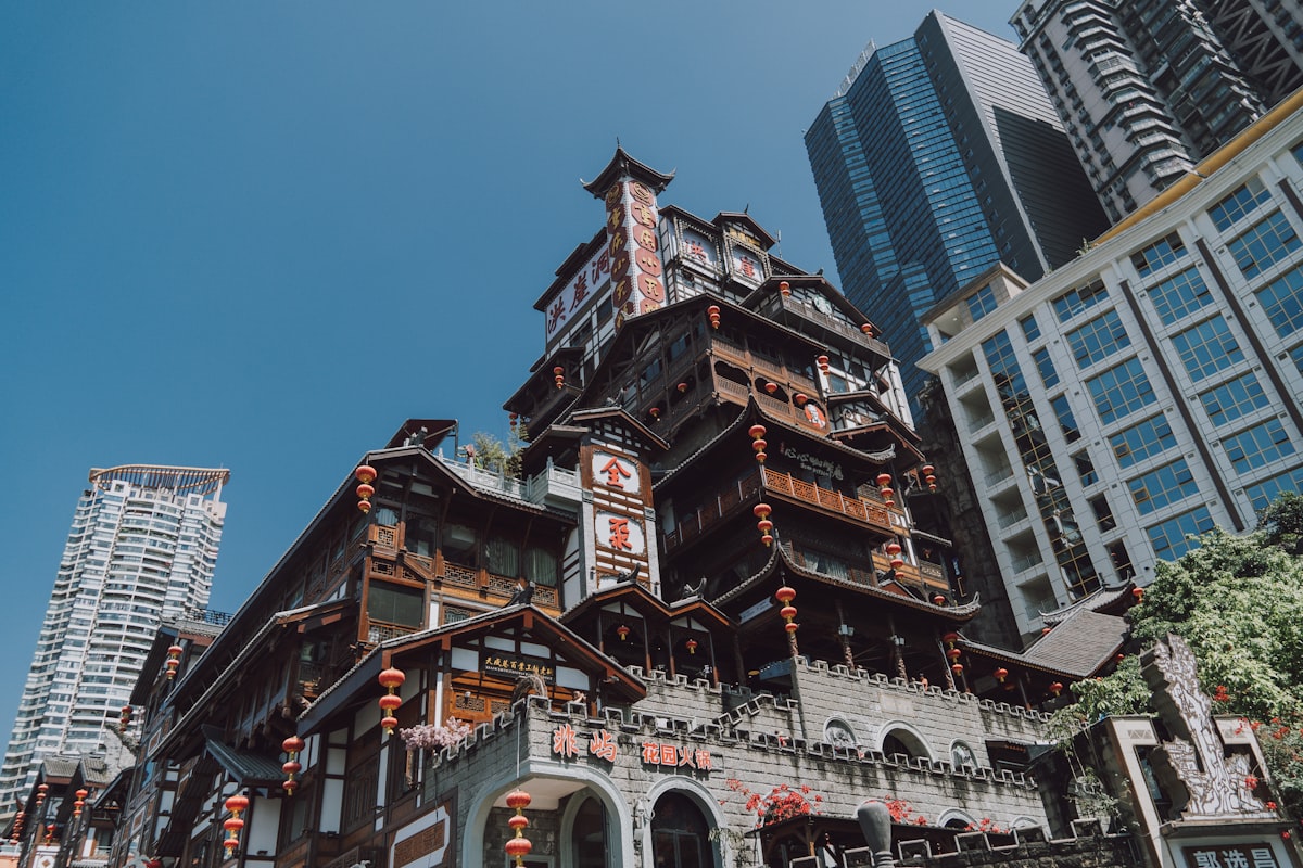 Traditional stilt-style architecture of Hongyadong against Chongqing's modern towers