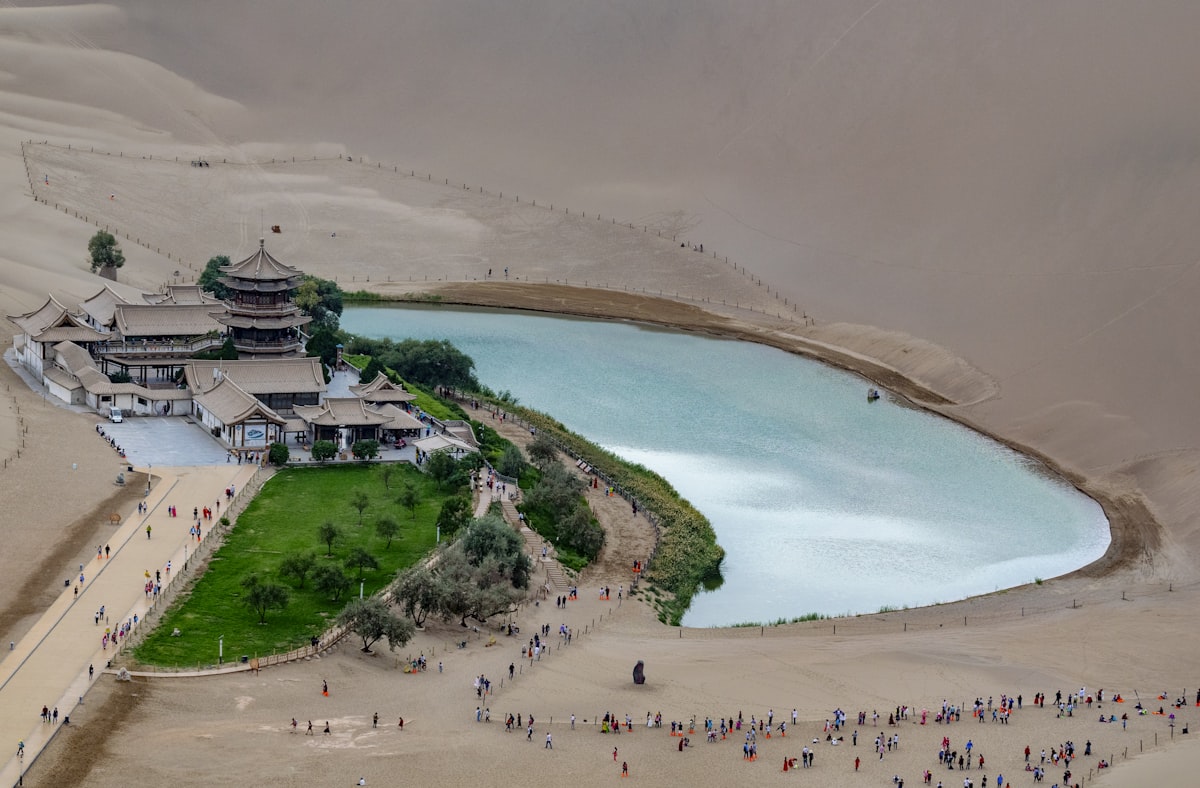 Aerial view of Crescent Lake oasis and its pagoda amid the dunes of Dunhuang