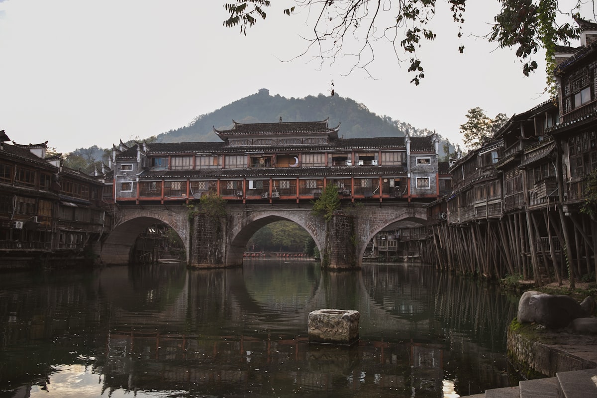 Hong Bridge spanning the Tuo River between timber houses in Fenghuang