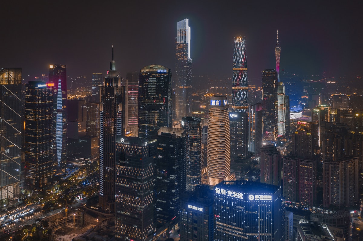 Guangzhou's skyscrapers lit up at night, with Canton Tower glowing in the distance