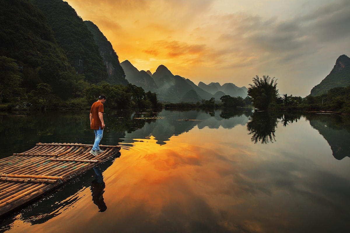 Bamboo raft on the Li River at sunset with karst mountains, Guilin