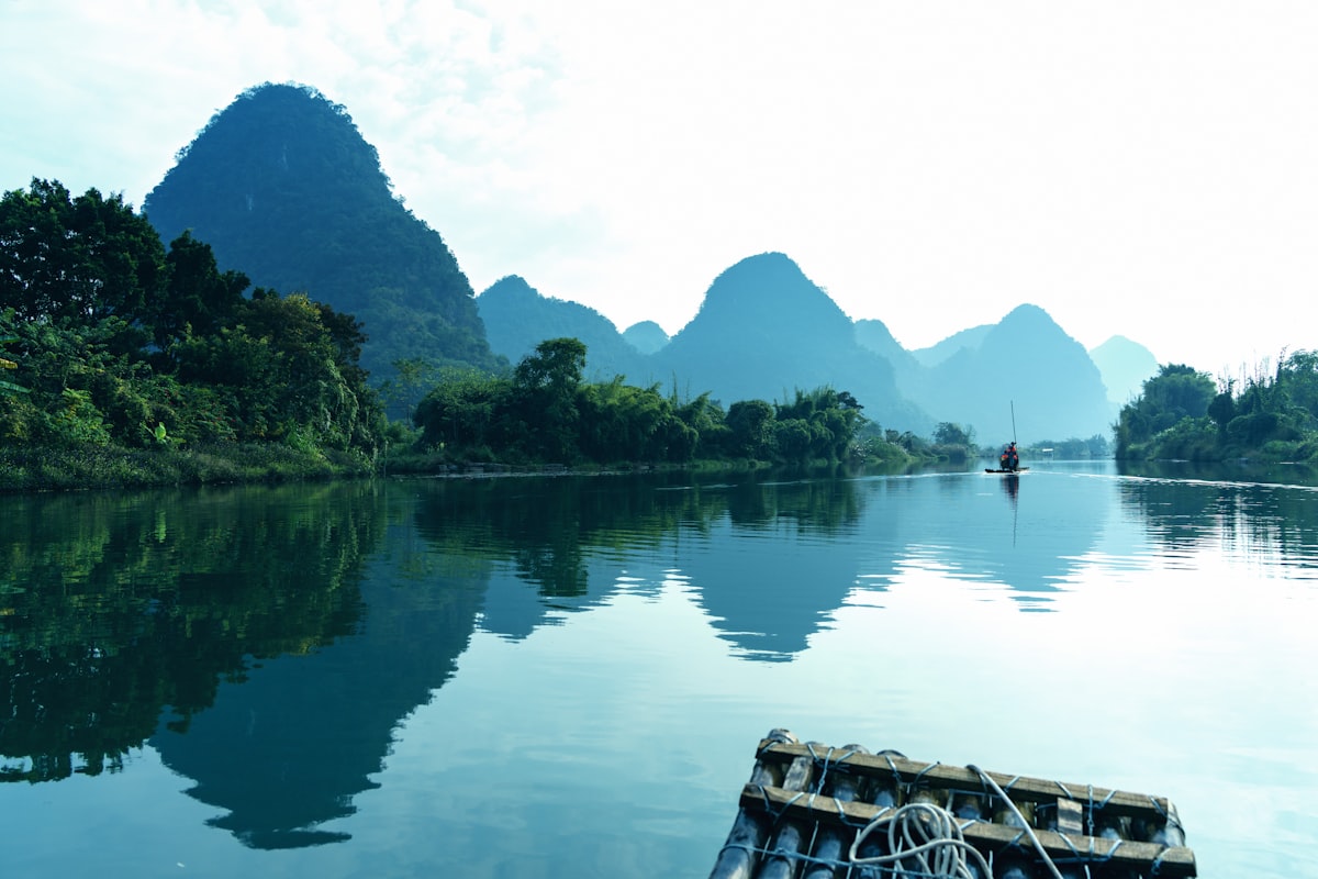 Karst peaks reflected in the calm Yulong River near Yangshuo, Guilin