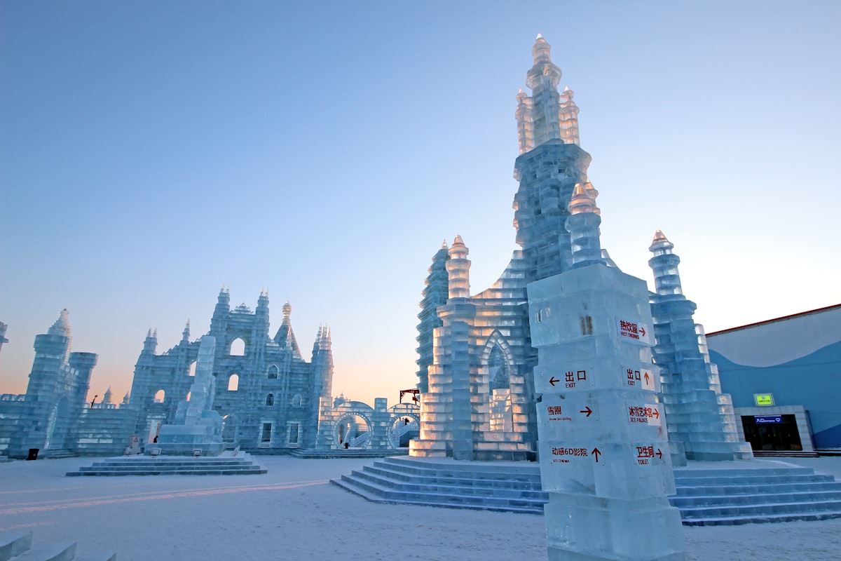 An ice castle at the Harbin Ice Festival in soft dawn light