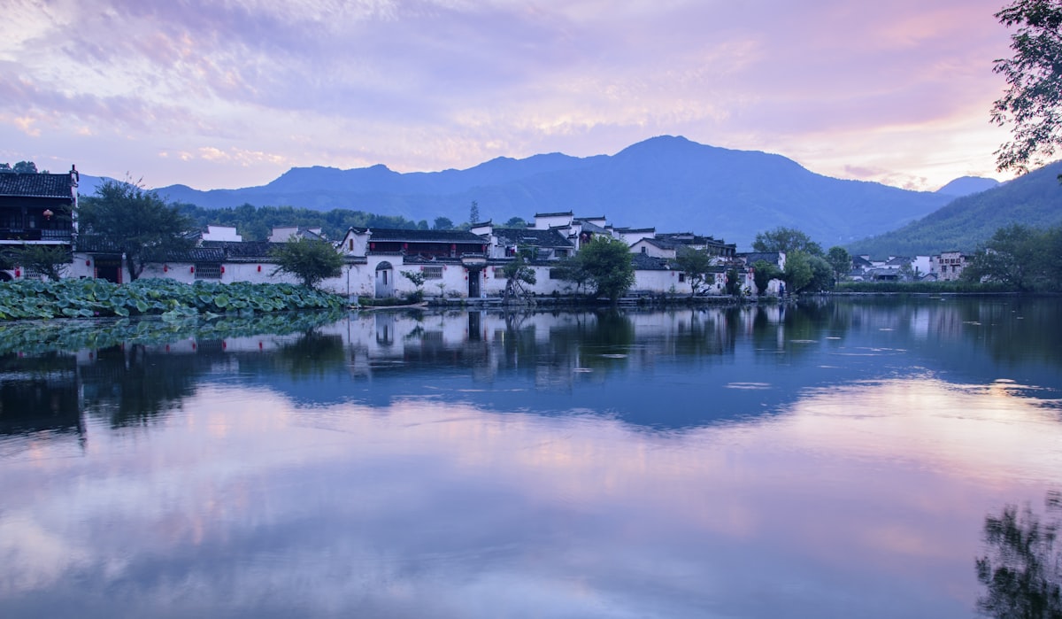 Evening light over Hongcun village reflected in the still water of South Lake