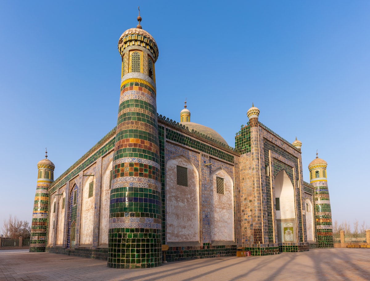 Green-tiled minarets of the Afaq Khoja Mausoleum in Kashgar at golden hour