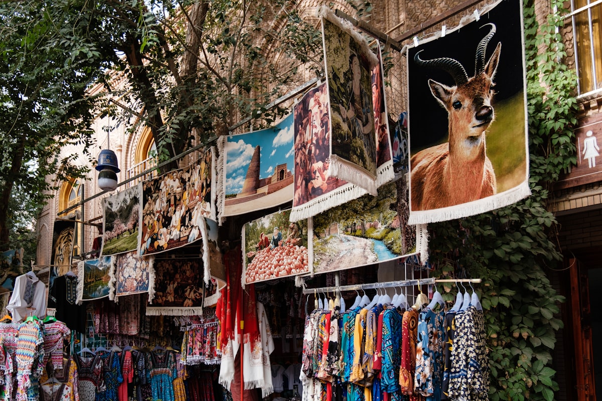 Carpets and dresses displayed at a bazaar stall in Kashgar Old City