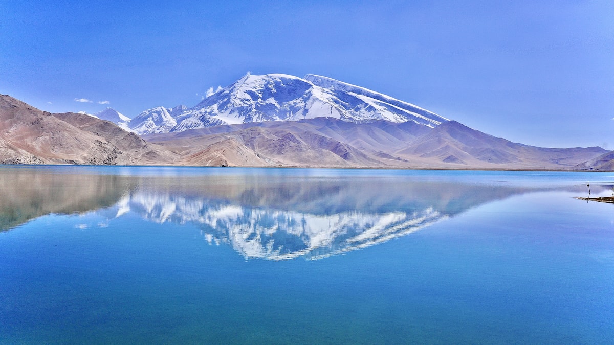 Muztagh Ata reflected in Karakul Lake along the Karakoram Highway near Kashgar