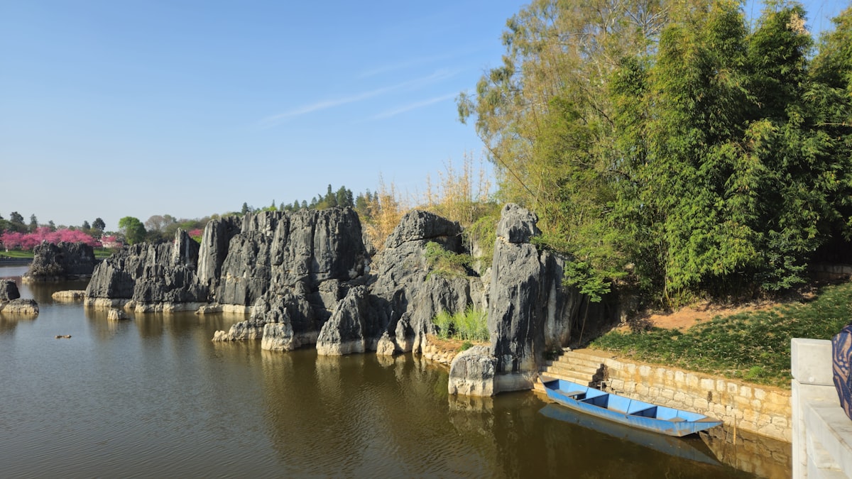 Limestone karst pinnacles rising beside a pond at the Stone Forest (Shilin) near Kunming
