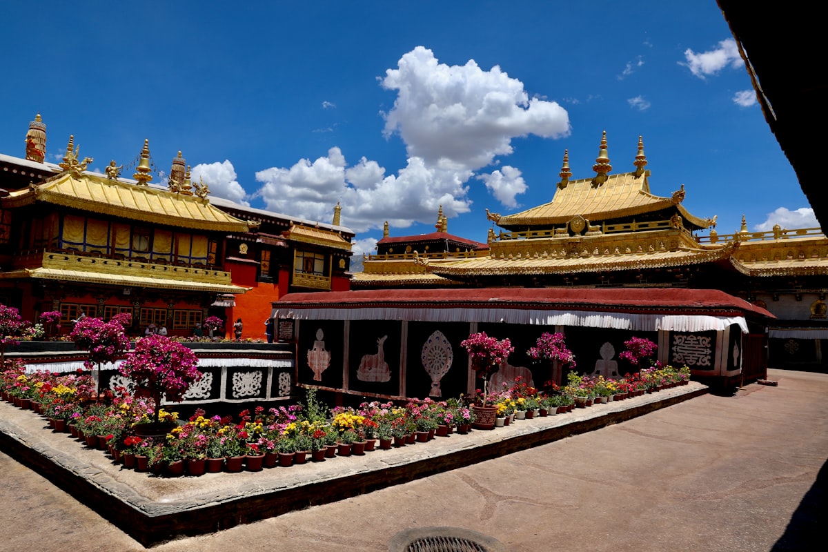 Gilded rooftops of Jokhang Temple with flower beds, Lhasa
