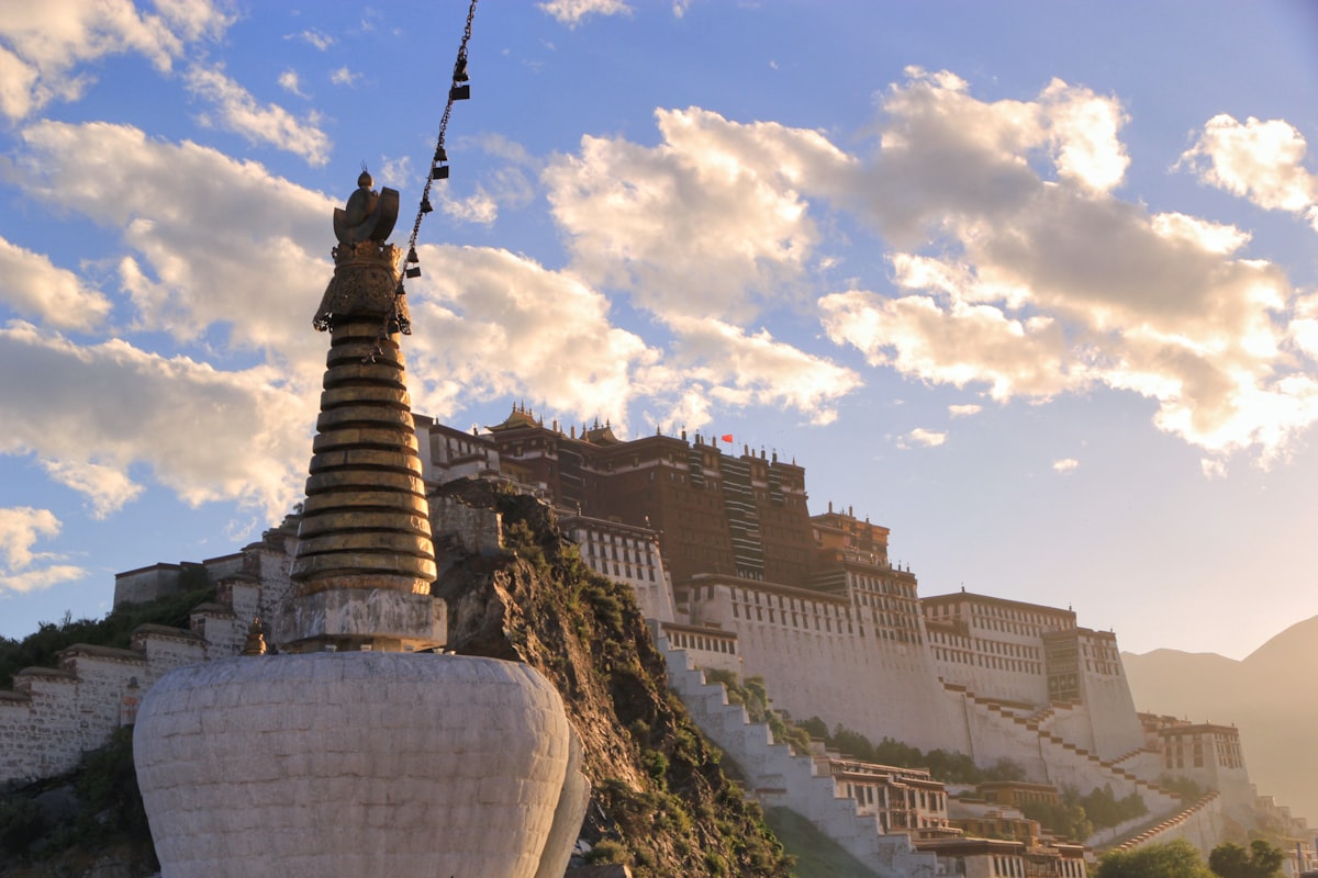 Golden-spired chorten and the Potala Palace at sunset, Lhasa