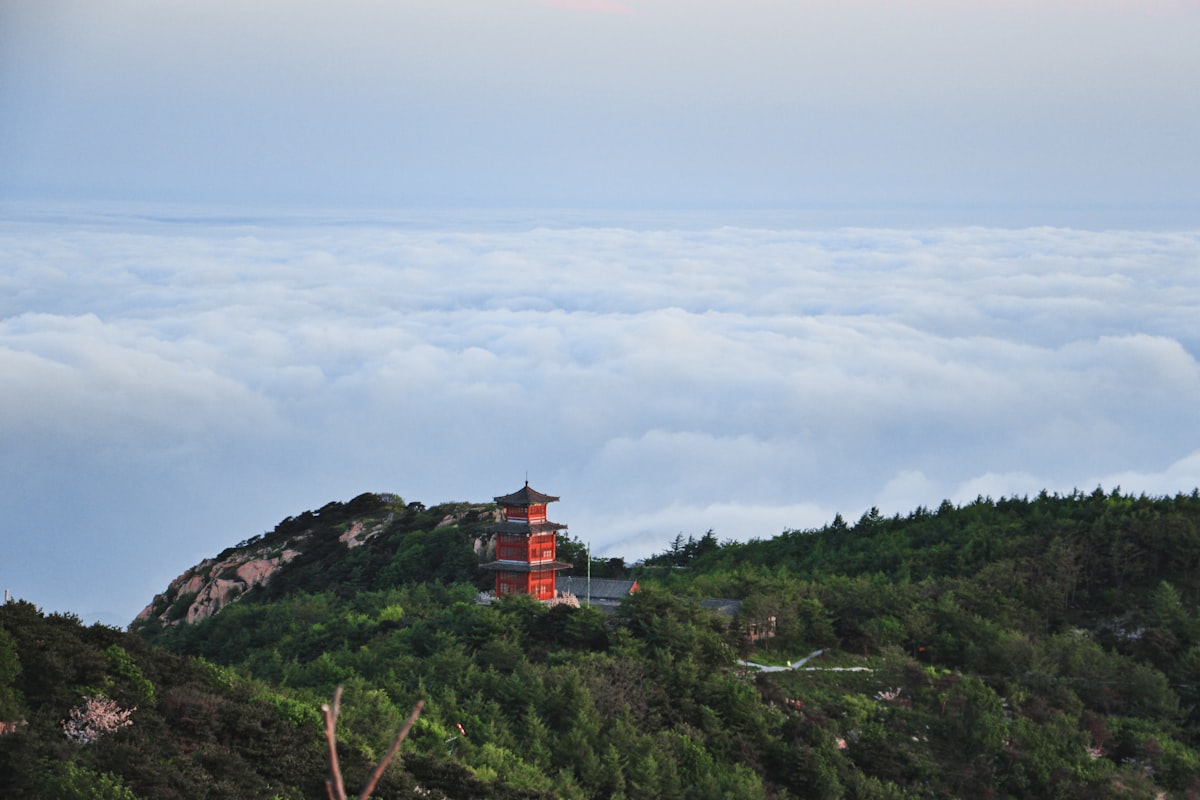 A red pavilion overlooks a sea of clouds near the summit of Mount Tai