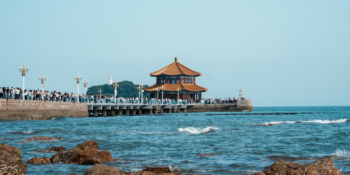Crowds on Zhanqiao Pier leading to Huilan Pavilion in Qingdao Bay