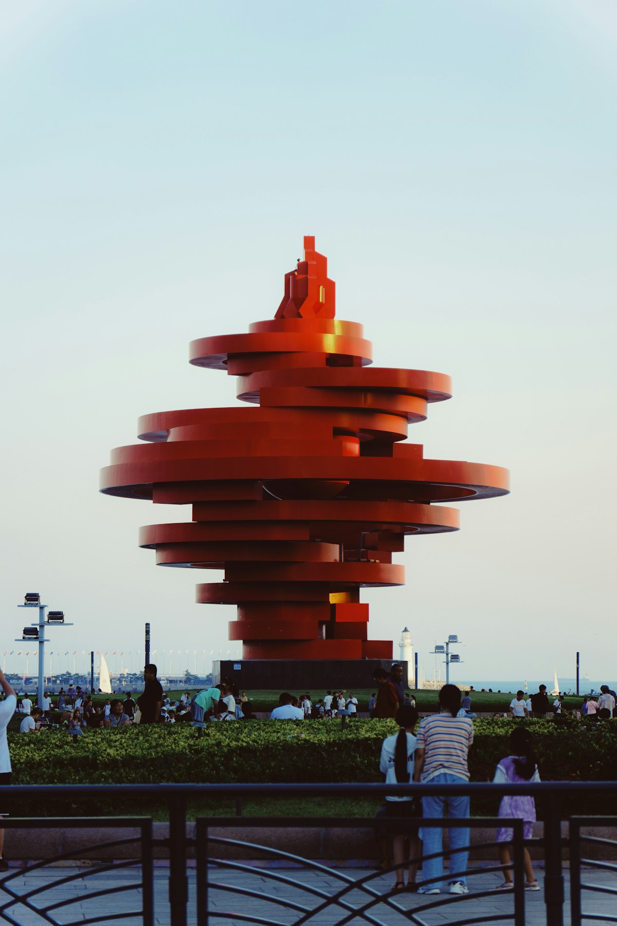 May Wind sculpture spiraling above visitors at May Fourth Square, Qingdao