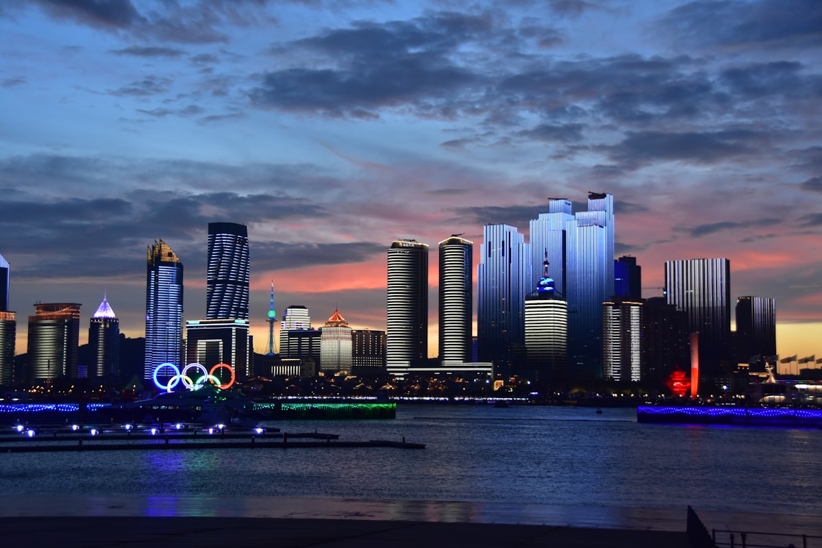 Qingdao's Fushan Bay skyline at dusk with the Olympic rings on the waterfront