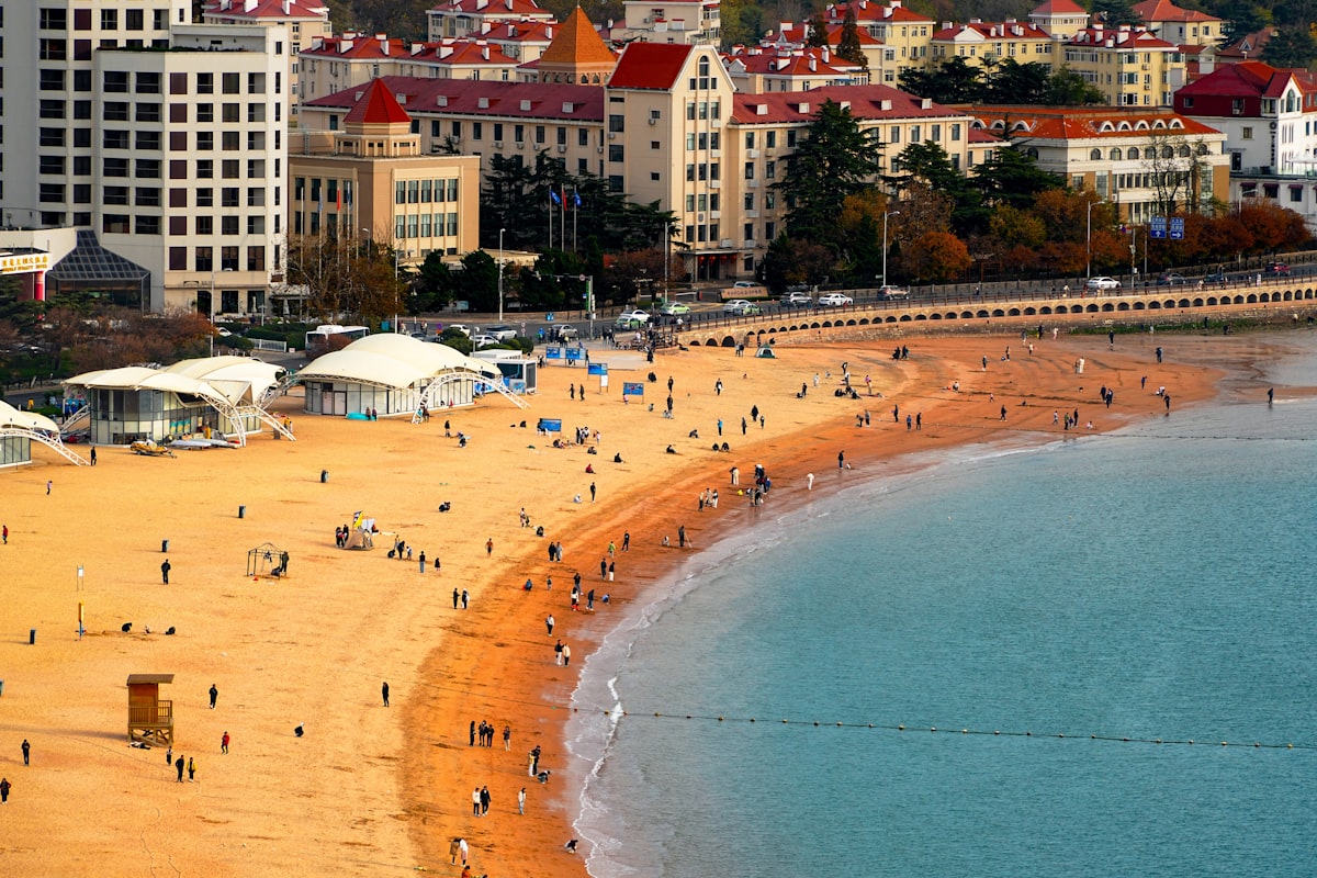 Bathers on the golden sand of a Qingdao swimming beach