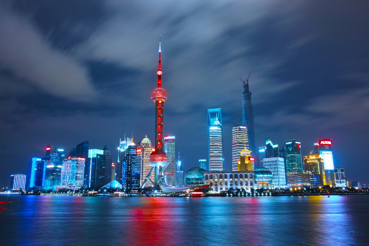 Shanghai's Pudong skyline lit up at night along the Huangpu River