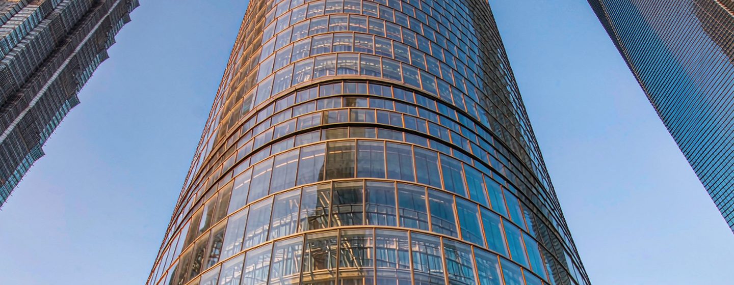 Shanghai Tower's twisting glass facade seen from street level