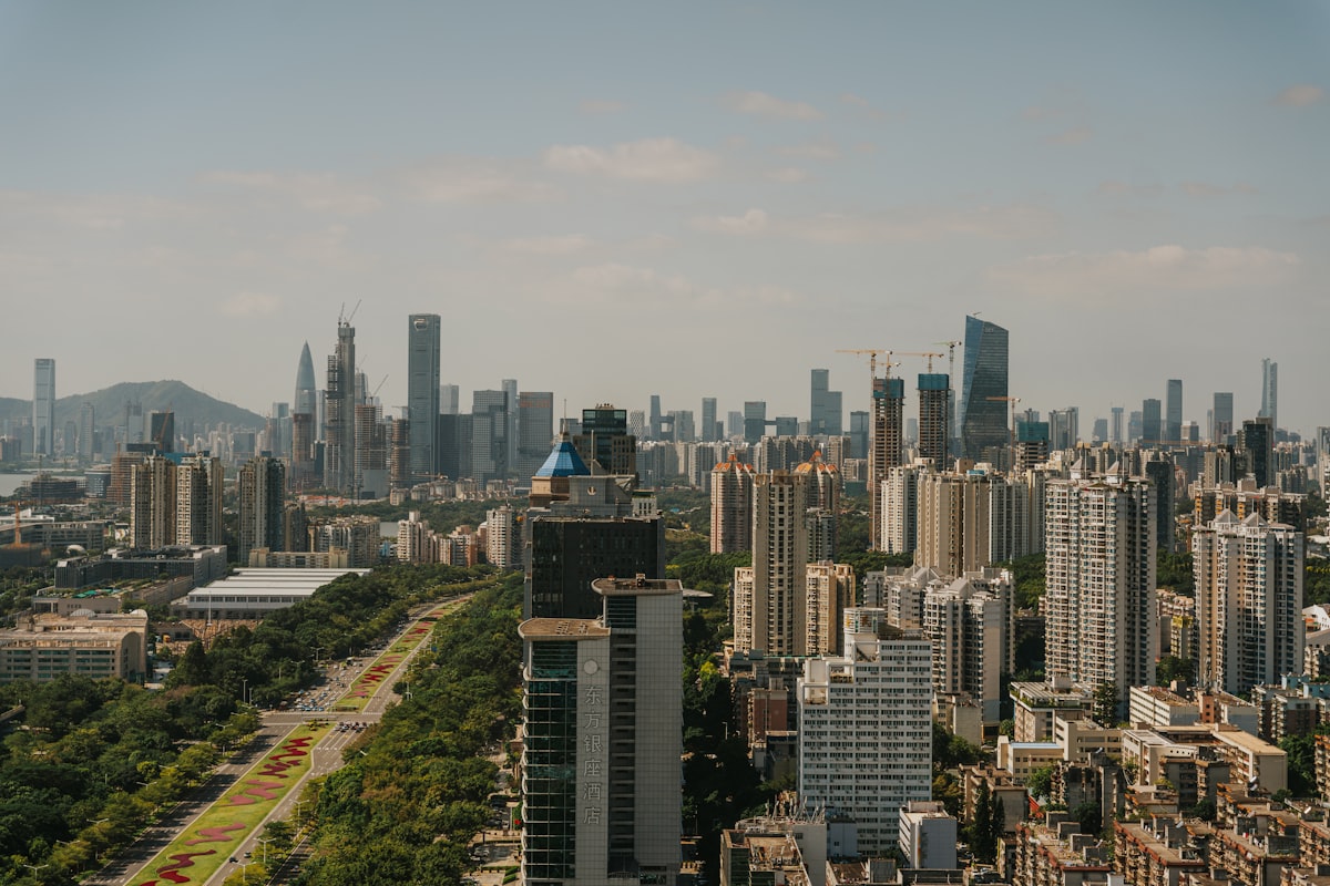 Tree-lined boulevard cutting through Shenzhen's high-rise districts