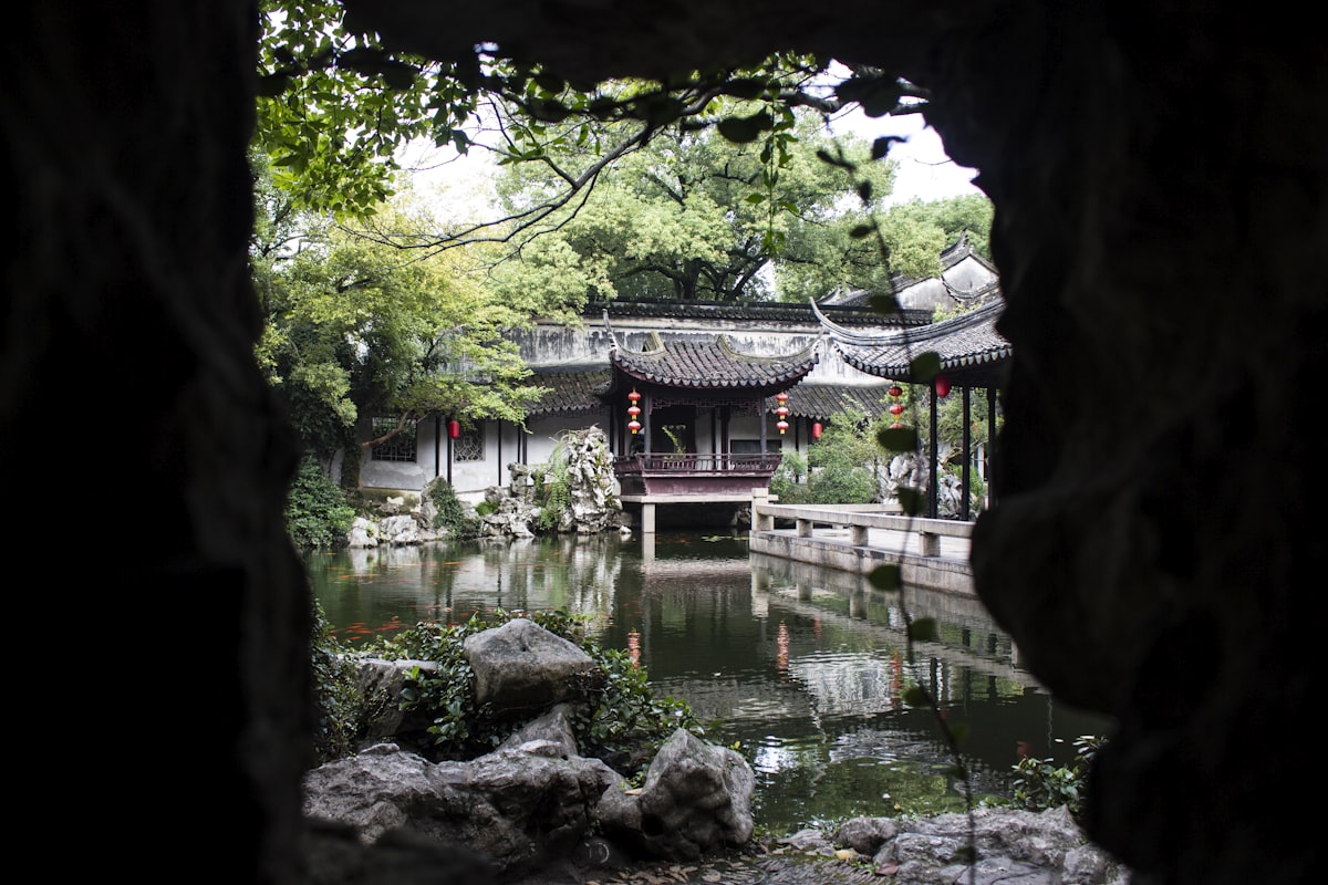 Lantern-hung pavilions of a Suzhou classical garden framed by a rockery cave