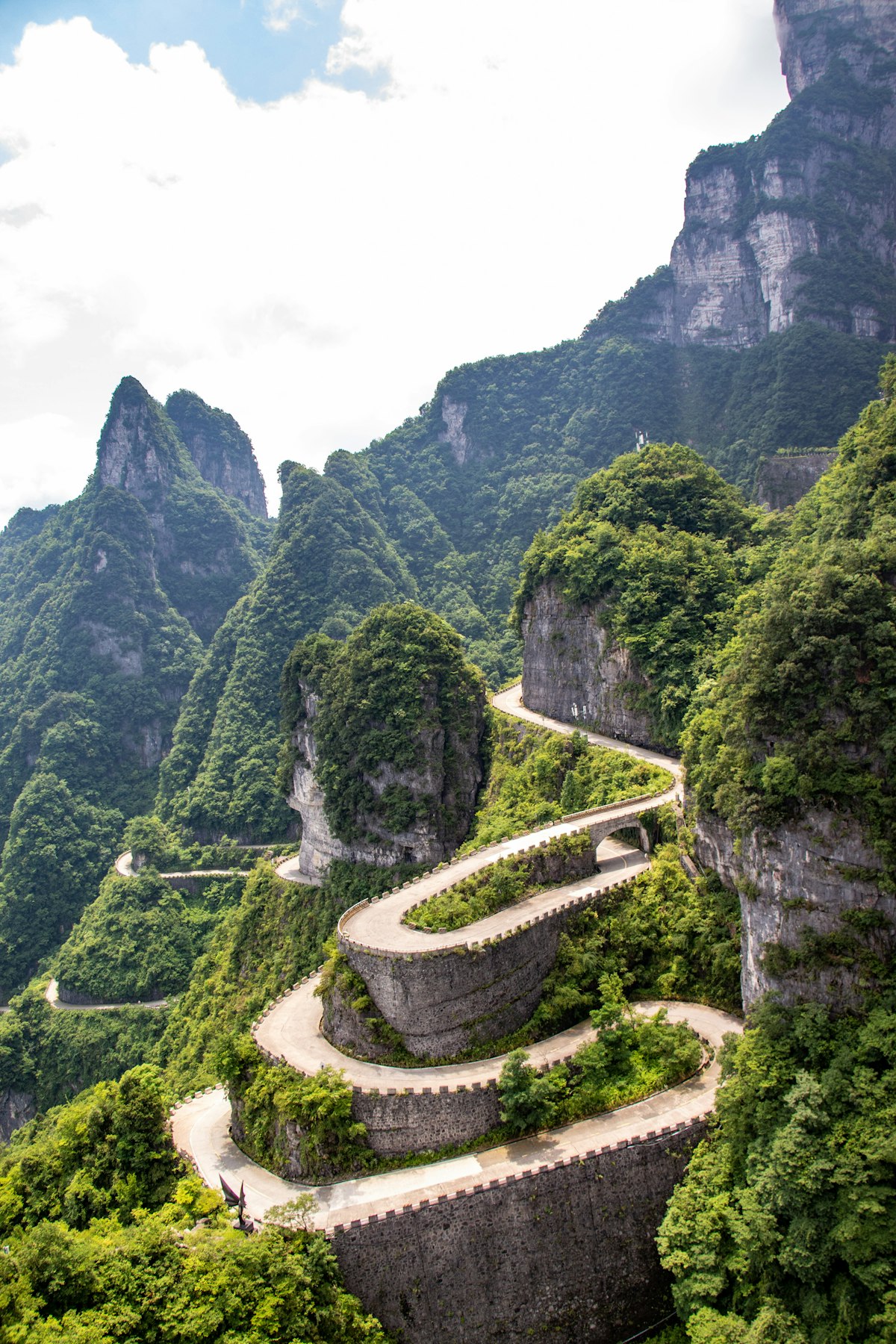 Hairpin bends of the Tianmen Mountain road climbing through green cliffs, Zhangjiajie