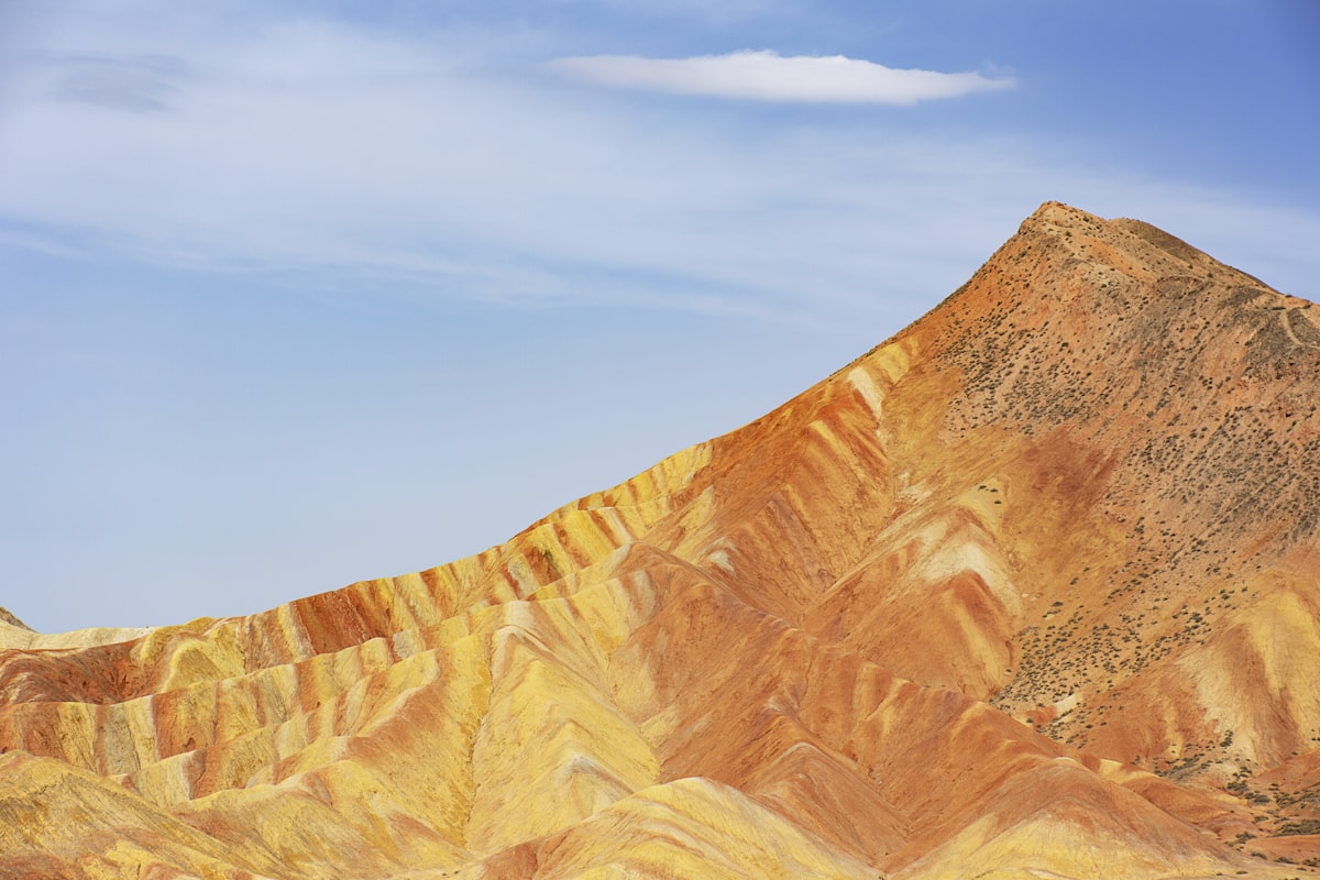 Ochre-striped peak under a blue sky in the Danxia hills of Zhangye