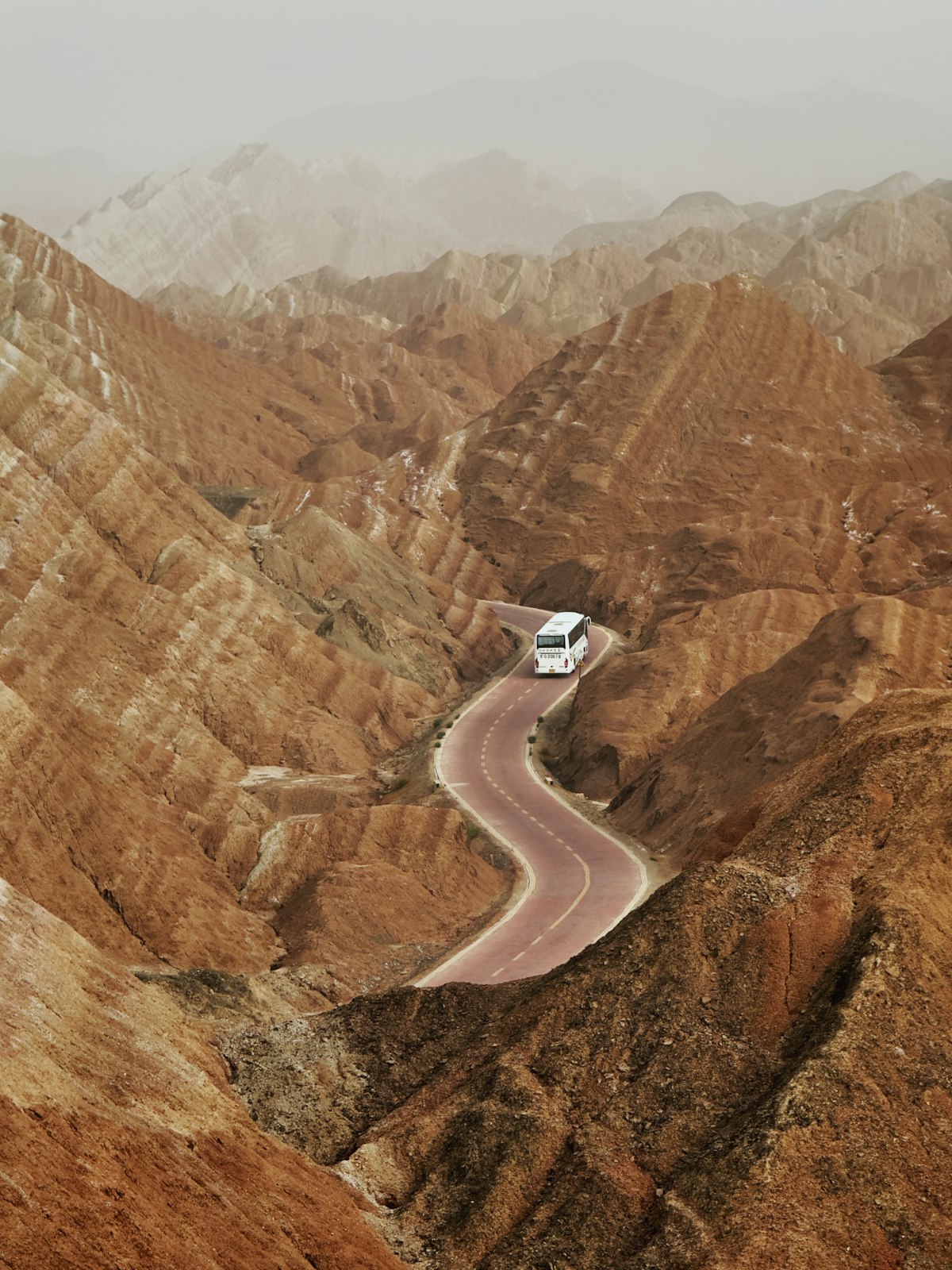 Shuttle bus winding through the red rock valleys of Zhangye Danxia park