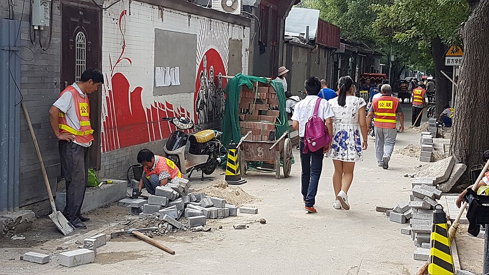 A lantern-strung hutong lane lined with food stalls in Beijing