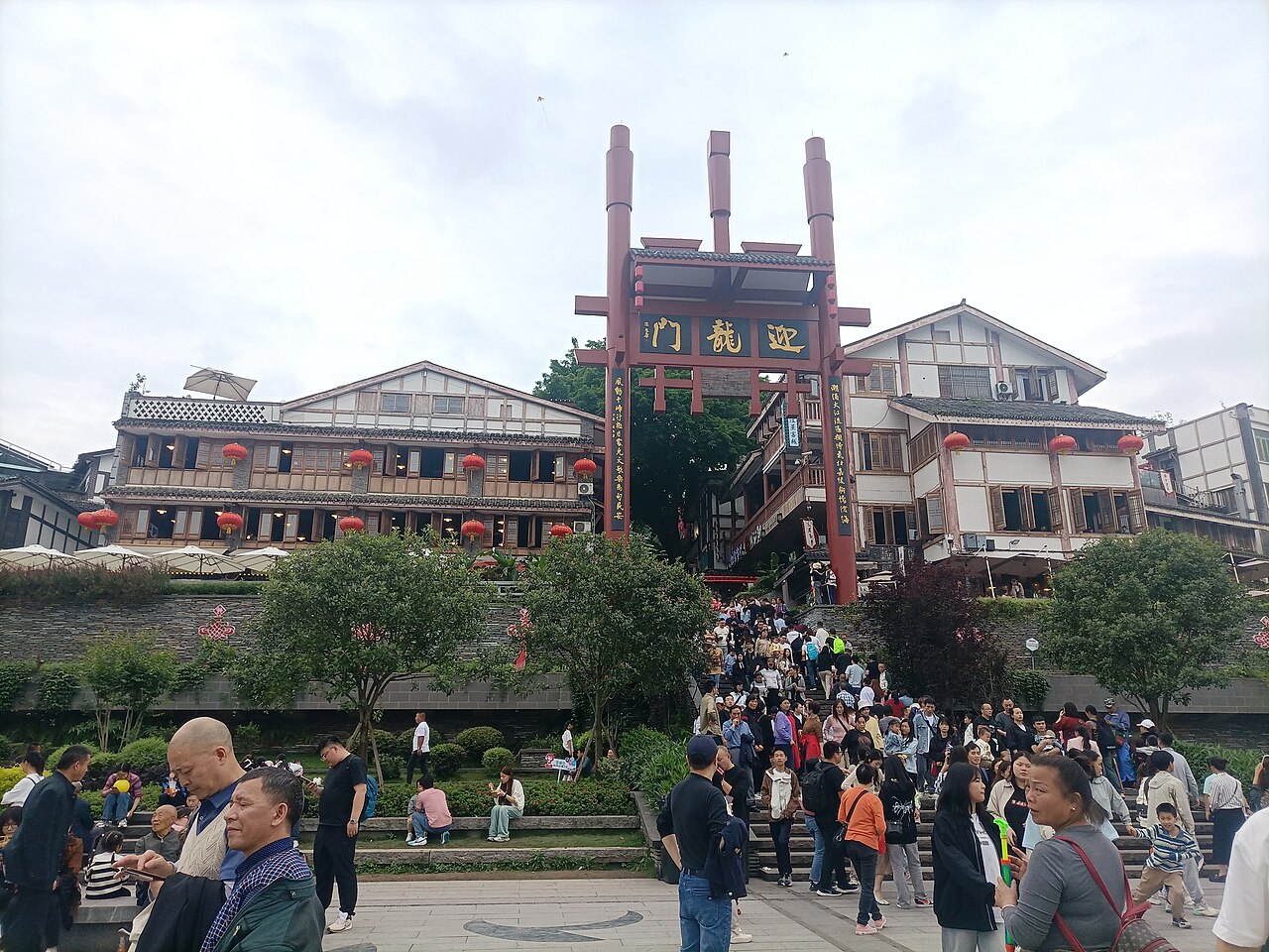 Crowds passing under the Yinglongmen gate at the entrance to Ciqikou old town, Chongqing