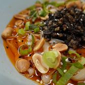 A small bowl of dandan noodles under peanuts, preserved vegetable and chilli oil
