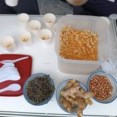 A Gongcheng oil-tea tray: cups of tea with bowls of puffed rice and peanuts