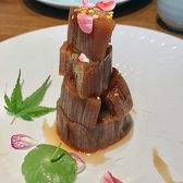 Slices of sweet lotus root stacked on a plate and scattered with osmanthus and petals