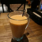 A glass of Hong Kong milk tea on a café table