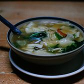 A bowl of thukpa: noodles and vegetables in broth