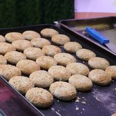 Rose cakes baking in rows on a griddle tray