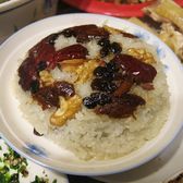 Eight-treasure rice turned out on a plate under dates and preserved fruit