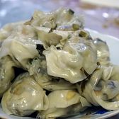 A plate of soup dumplings, pleated and glossy
