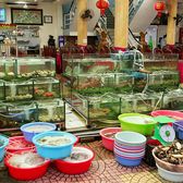 Live seafood tanks lined up in a restaurant window
