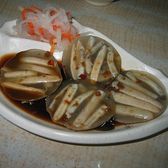 Discs of sandworm jelly on a plate in dark sauce