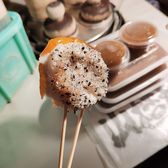 A jinggao rice cake handed over on a stick