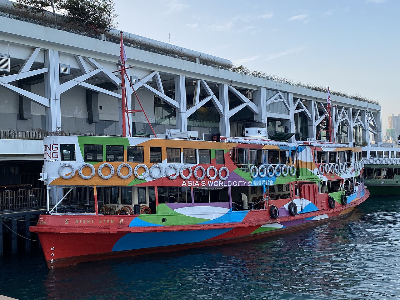 A green and white Star Ferry at its pier in Hong Kong