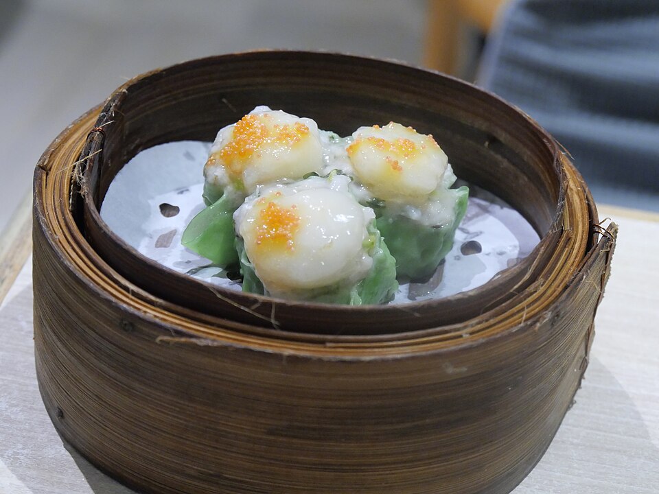 A bamboo steamer of seafood siu mai