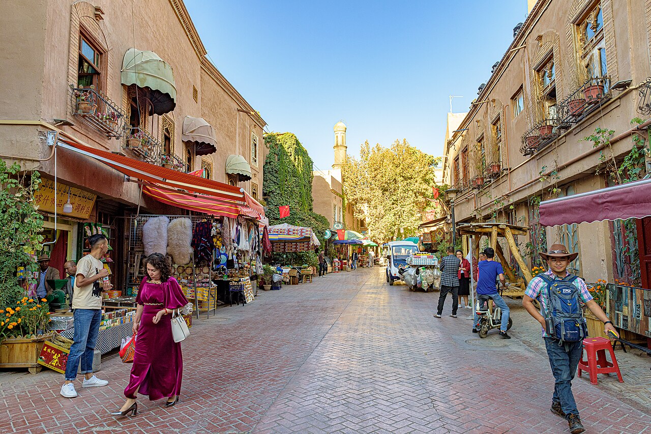 A street of the Kashgar old town with shopfronts and people walking