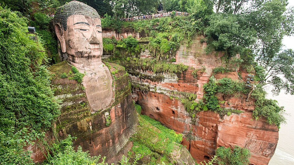 The colossal Leshan Giant Buddha carved into the cliff above the river