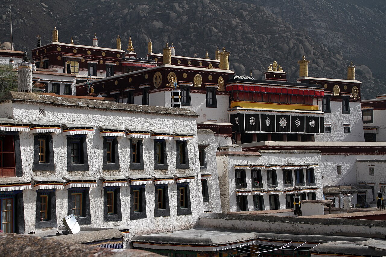 The white buildings of Drepung Monastery stacked up the hillside outside Lhasa